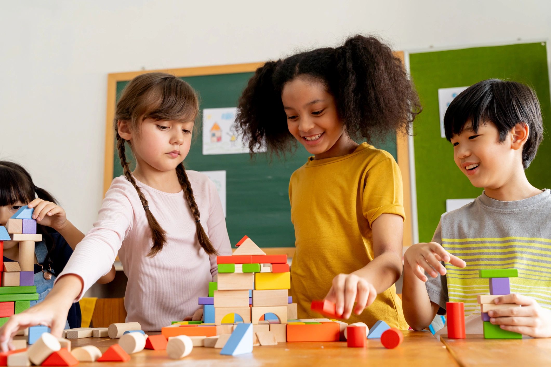Children building with blocks together in a classroom