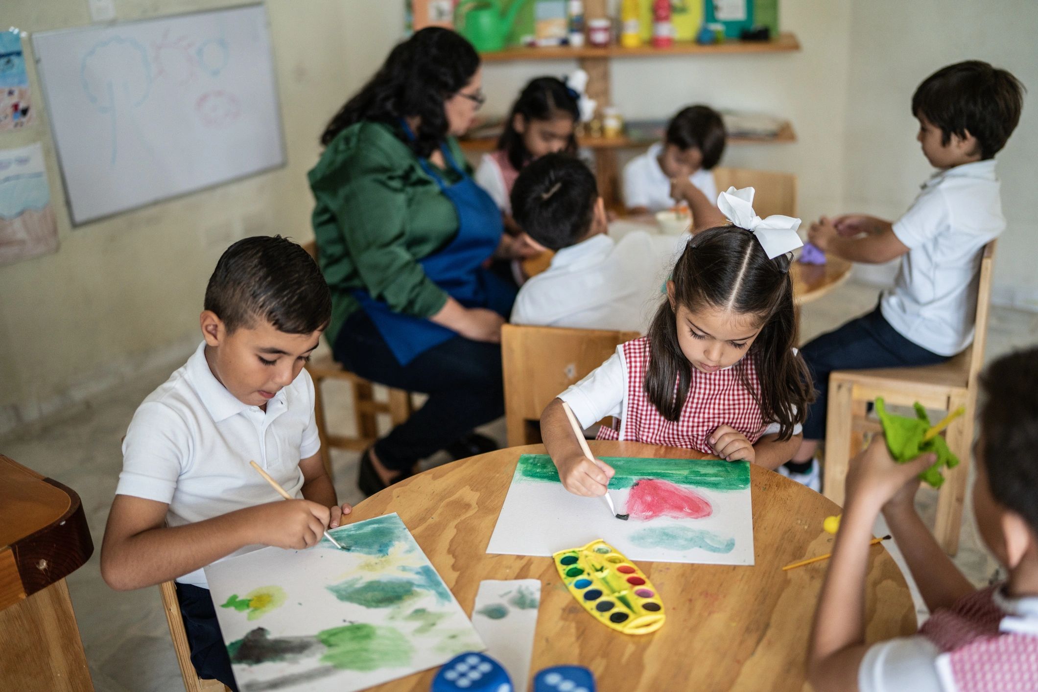 Children painting together during an art activity