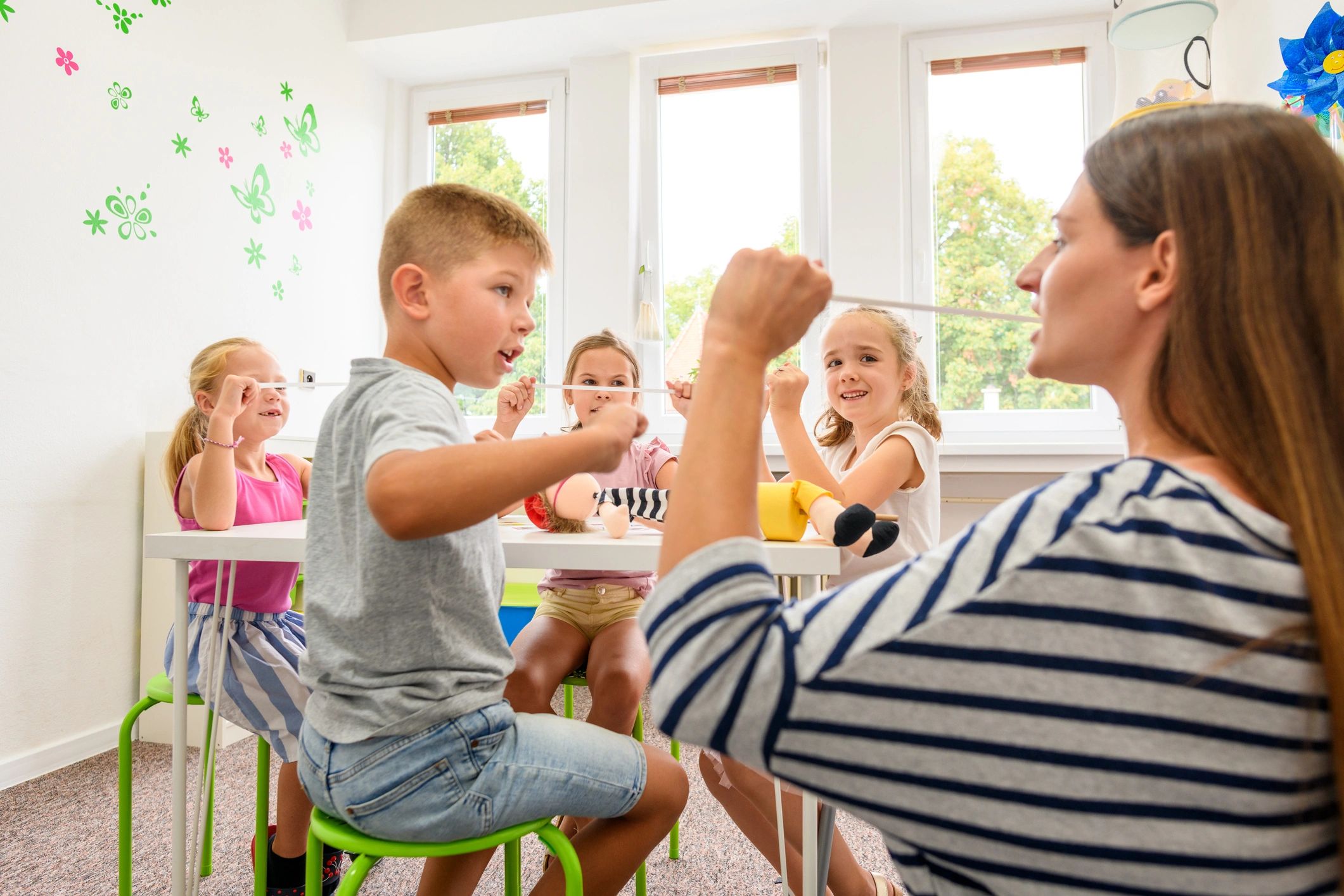 Children doing playful movement activities with an adult
