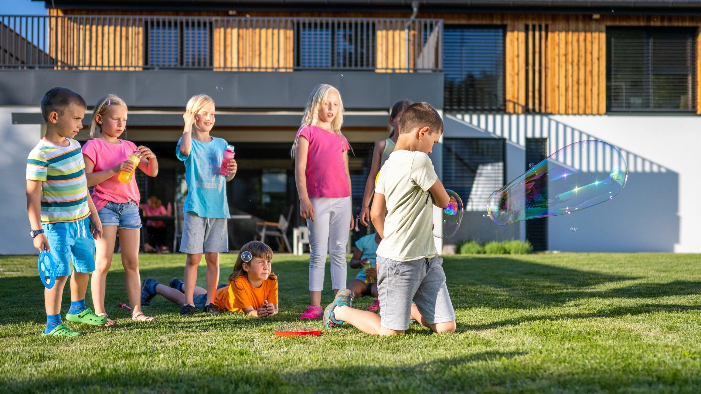 Children blowing soap bubbles outdoors