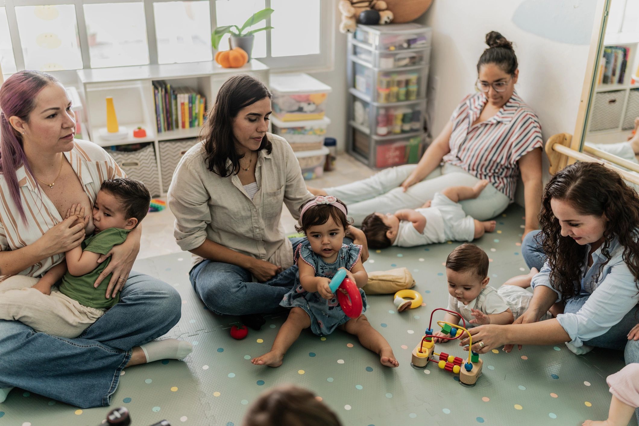 Parents and babies playing together in a playroom