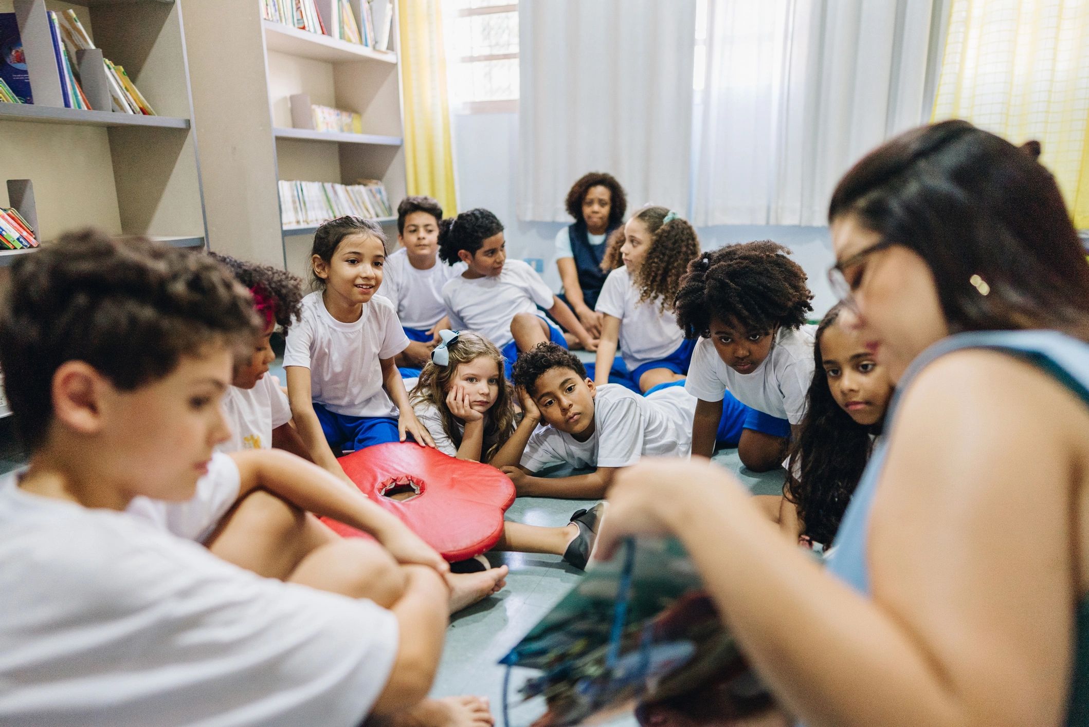 Teacher reading to children during circle time