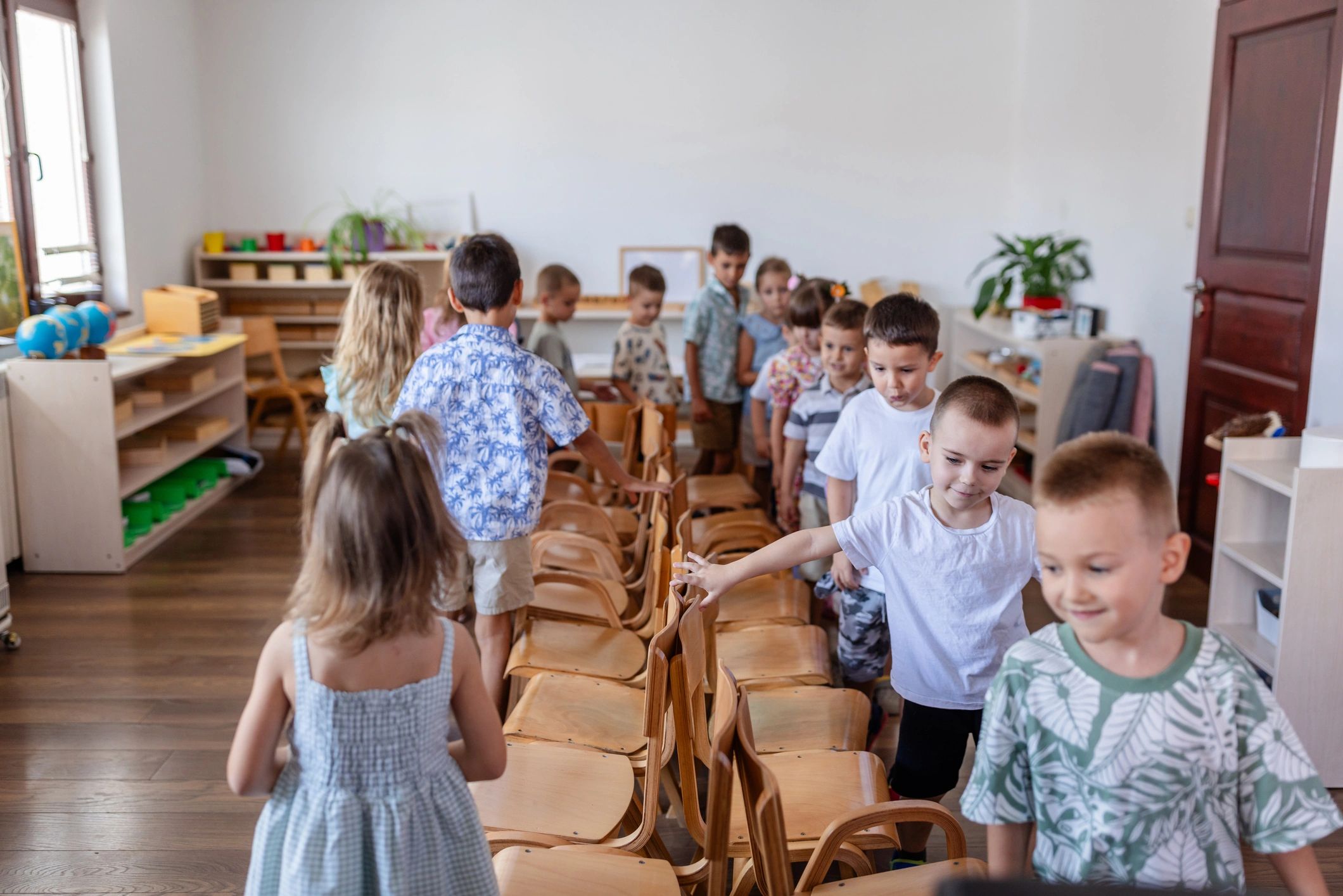 Children playing musical chairs in a classroom