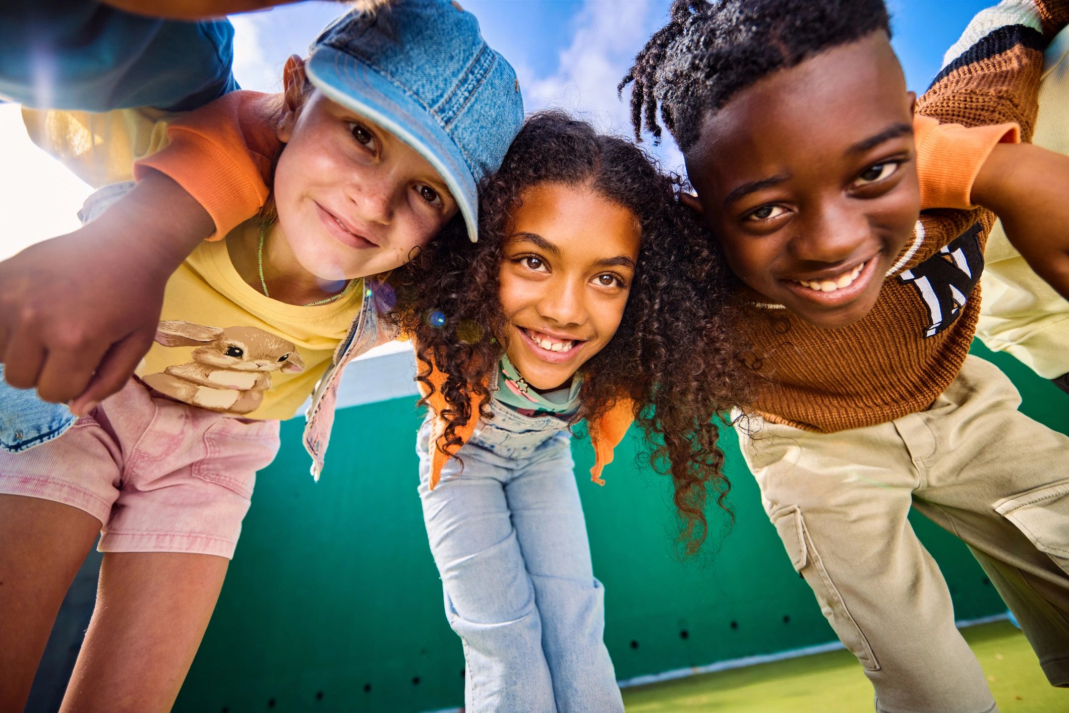 Group of children hugging and smiling on a playground
