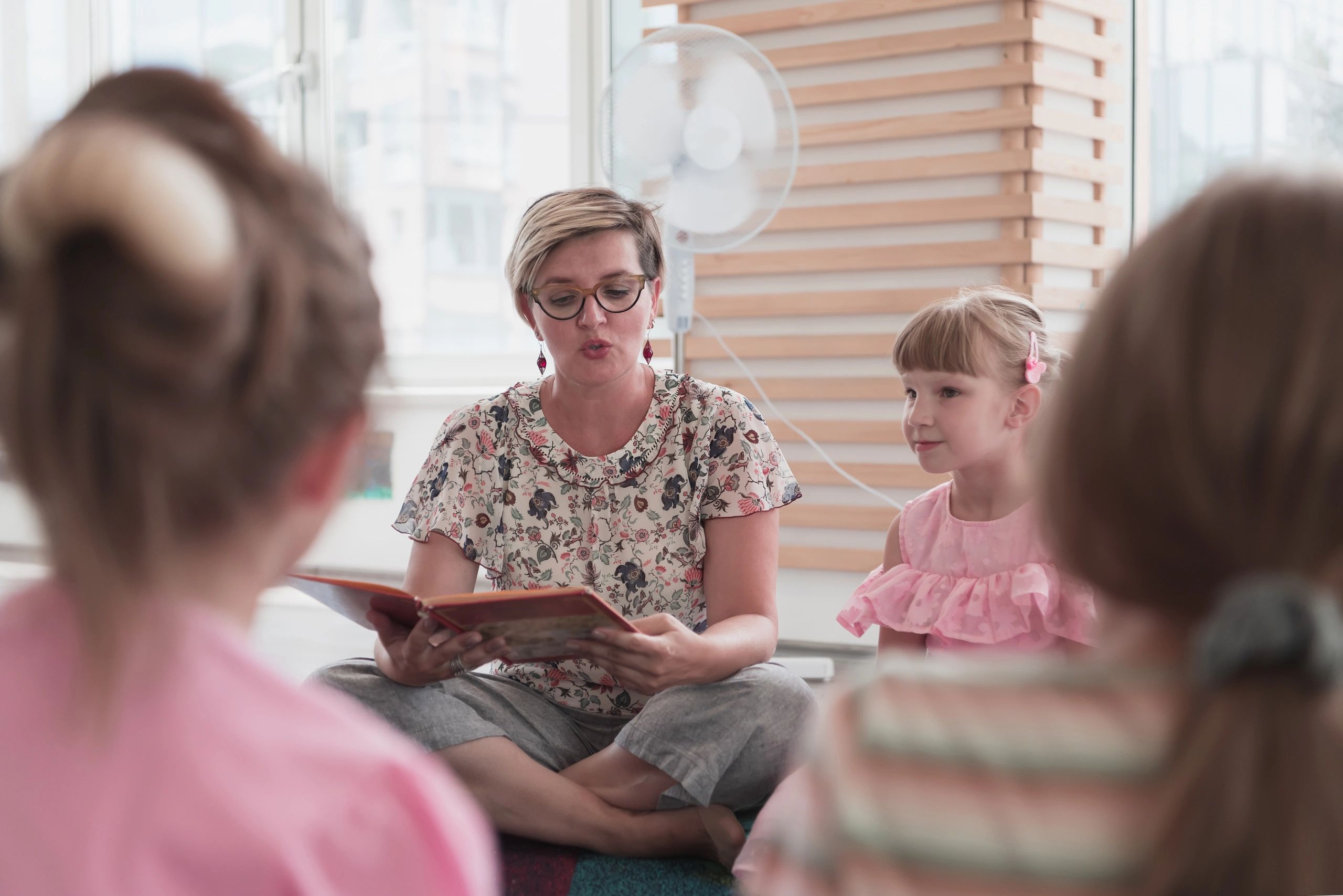 Teacher reading a story to children during circle time